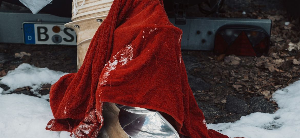 A red cloth draped over a metal bell